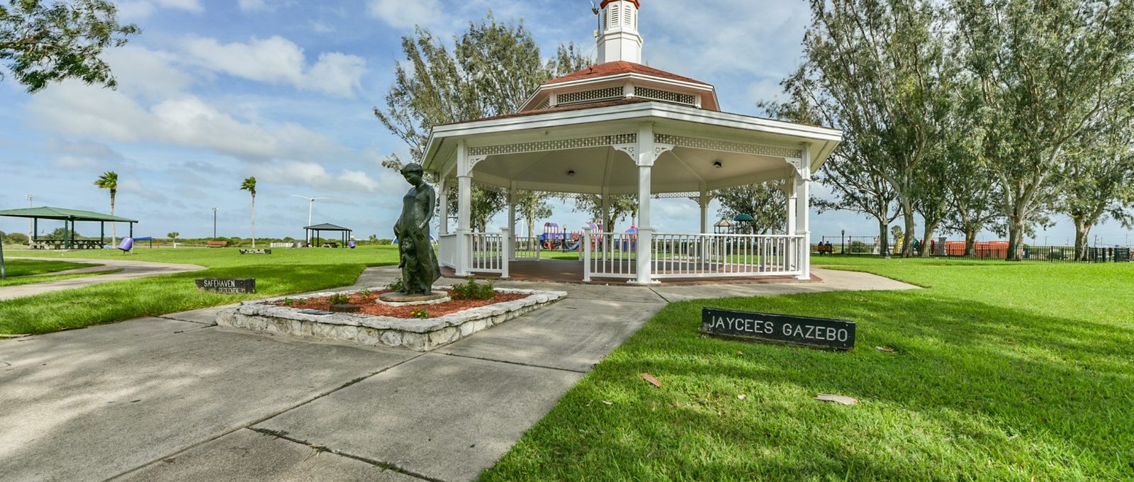a gazebo sits in the middle of a park at The Shoal Pointe Apartments