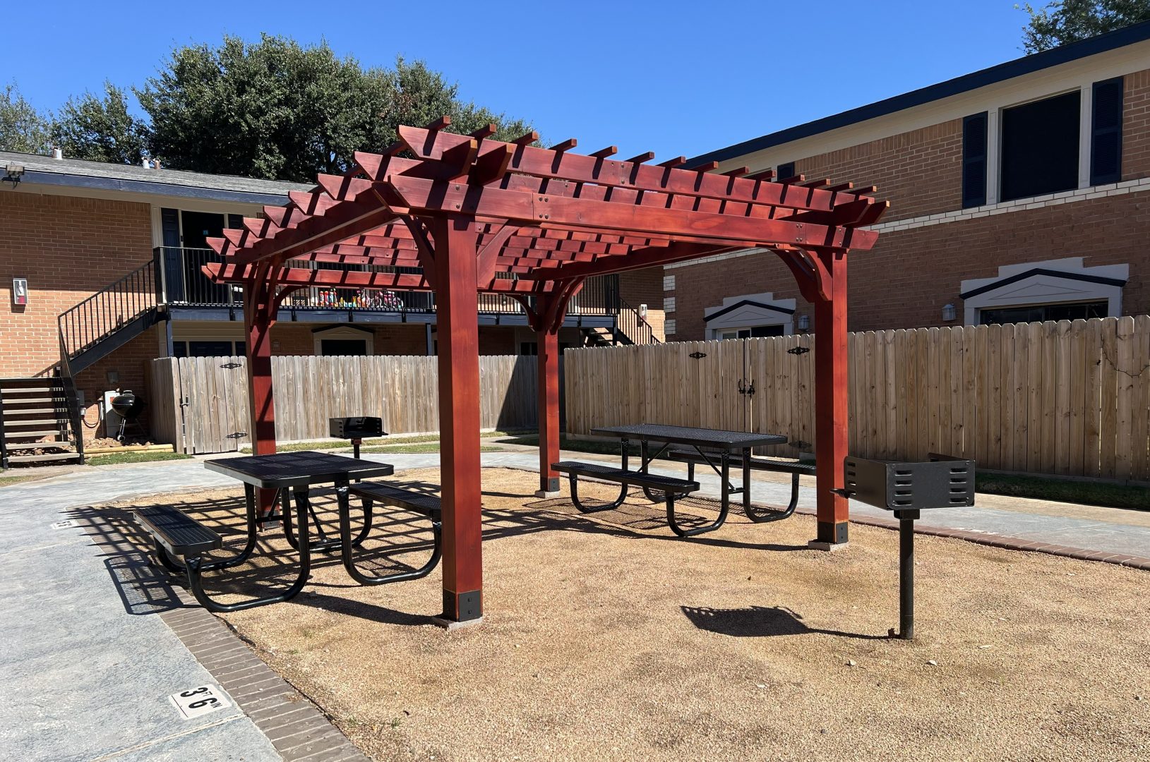 a picnic table with chairs and umbrellas